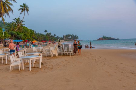 Photo for Mirissa, Sri Lanka, January 22, 2022: Sunset view of a beach restaurant at Mirissa beach, Sri Lanka. - Royalty Free Image