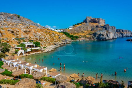 Photo for Lindos, Greece, September 2, 2022: Saint Paul's beach at Greek town Lindos at Rhodes island. - Royalty Free Image