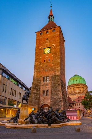 Photo for Nurnberg, Germany, August 11, 2022: Sunrise view of ehekarussell fountain and the white tower in Nurnberg, Germany.. - Royalty Free Image