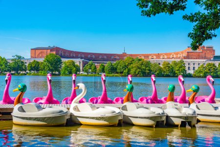 Photo for Nurnberg, Germany, August 11, 2022: Swan boats and former Nazi congress hall in Nurnberg, Germany. - Royalty Free Image