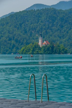 Assumption of Maria church at lake Bled viewed from the castle bathing area in Slovenia