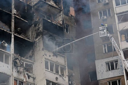 Ukrainian rescuers extinguish a fire in a residential building following a missile attack in Kyiv on February 7, 2024, amid the Russian invasion of Ukraine.