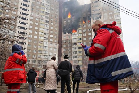 Emergency services stand near the site of a missile attack in a residential area of the city on February 07, 2023 in Kyiv, Ukraine.