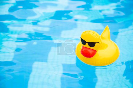 Photo for Inflatable Swimming sunglasses duck floating in the pool - Royalty Free Image