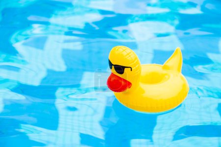 Photo for Inflatable Swimming sunglasses duck floating in the pool - Royalty Free Image