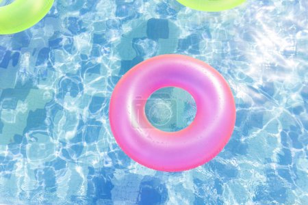 Photo for Inflatable pool with swimming ring and rings in a water on blue background in the summer day. - Royalty Free Image