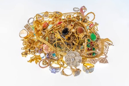 Horizontal shot of a colorful pile of beautiful vintage gold jewelry.