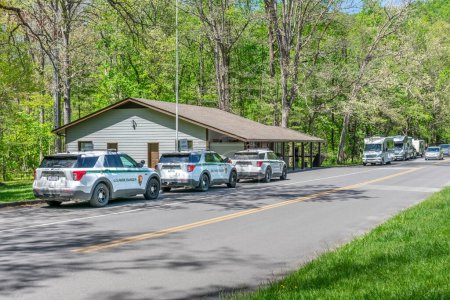 Photo for Cades Cove, TN, United States  April 24, 2023: Horizontal shot of tourists leaving the Cades Cove Snack Bar and Gift Shop in the Great Smoky Mountains National Park. - Royalty Free Image