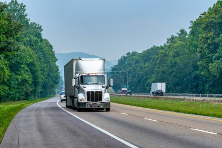 Photo for Horizontal shot of a white eighteen wheeler on an interstate with room to crop. - Royalty Free Image
