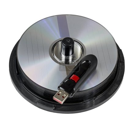 Horizontal close-up shot of a high capacity USB Flash On Stack of CD Discs.