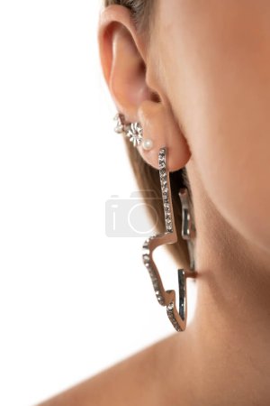 Photo for Ear piercings and five ear rings photos.Helix piercing.Ear rings. Close up. - Royalty Free Image