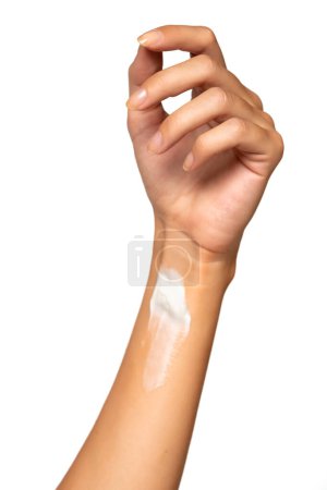 Foto de Close up cropped woman hand perfect skin hand cream isolated on white studio  background. Skin care healthcare procedures concept. Posing with  moisturizer on arm. - Imagen libre de derechos