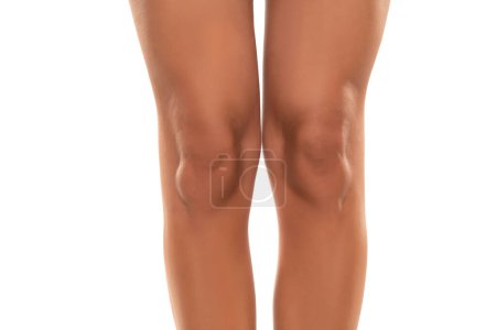Photo for Front view of beautifully cared women's legs and knees on white studio background. - Royalty Free Image