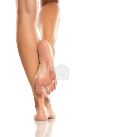 Photo for Pretty woman legs and sole feet on white studio background - Royalty Free Image