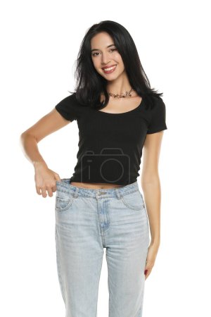 Photo for Weight loss happy woman isolated on a white studio background. Slim Body - Royalty Free Image