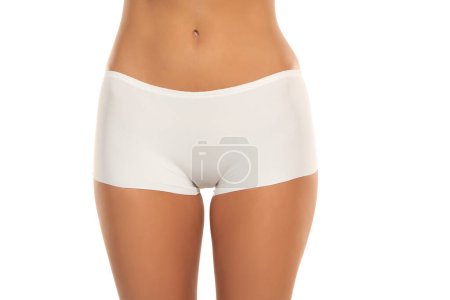 Photo for Mid section of woman wearing white briefs,  front view on a white studio background. - Royalty Free Image