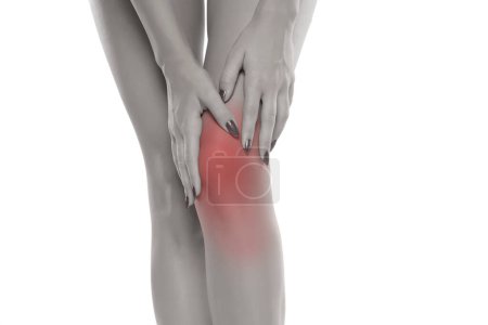 Photo for Woman holding her painful knee on white studio background. - Royalty Free Image