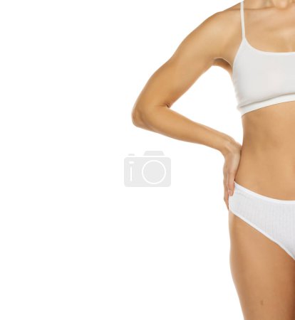 Photo for Slim woman in top form, perfect body shape. Parts of woman body in underwear, studio white background shoot. - Royalty Free Image