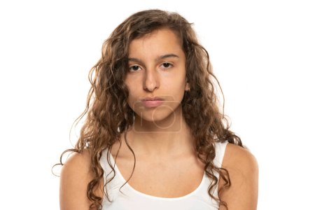 Photo for Portrait of a young woman without makeup and long wavy hair on a white studio background - Royalty Free Image