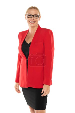Photo for Middle aged senior business smiling woman in red jacket and skirt on white studio background - Royalty Free Image