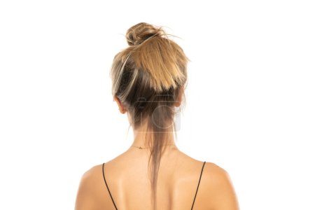 Photo for Young woman with messy loose bun on a white studio background. back, rear view - Royalty Free Image