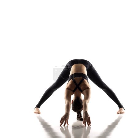 Photo for Yoga, sport, training and lifestyle concept - Young woman doing yoga exercise. Portrait of young beautiful woman in black sportswear doing yoga practice. - Royalty Free Image
