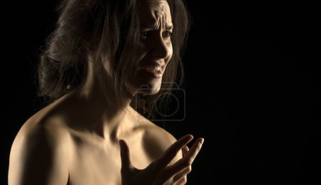 Photo for Silhouette of young unhappy crying woman on black studio background - Royalty Free Image