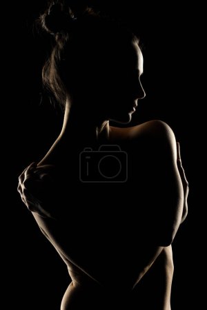 Photo for Sensual portrait silhouette of beautiful woman in backlight on a black studio background - Royalty Free Image