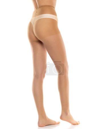 Photo for Woman wearing tights isolated on white, closeup of legs on a white studio background. Profile, side view - Royalty Free Image