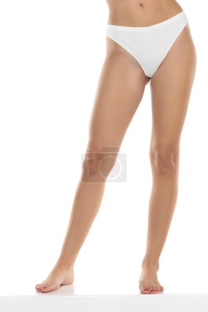 Photo for Perfect female legs in underwear on a white studio background. Front view - Royalty Free Image