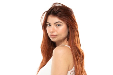 Photo for Portrait of serious beautiful woman with long straight ginger hair on a white studio background - Royalty Free Image
