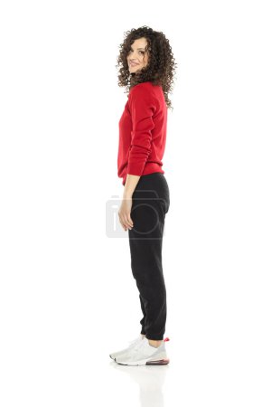 Photo for Young curly happy woman posing on white studio background. Side, profile view. - Royalty Free Image
