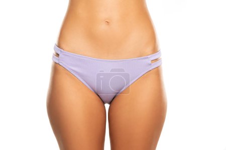 Photo for Front view of female hips with lilac panties on white studio background - Royalty Free Image