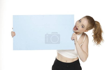Photo for Banner of young happy blonde woman feeling happiness and holding blue Empty white canvas frame for text or advertising isolated on white studio background - Royalty Free Image