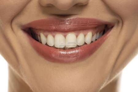 Photo for Close-up of a woman's mouth, capturing a confident smile and perfect natural teeth and lips. - Royalty Free Image