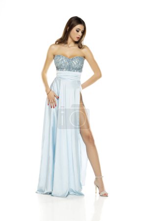 Photo for Full length of gorgeous elegant sensual brunette woman wearing fashion blue evening dress isolated on white studio background - Royalty Free Image