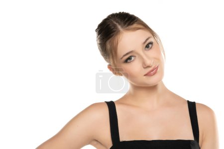 Radiant Elegance: Portrait of a Smiling Young Woman with Makeup, Updo, and Eye Contact on White Studio Background