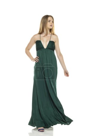 Photo for Full body front view portrait of elegant lovely blond lady  walking isolated on white studio background in green long dress - Royalty Free Image