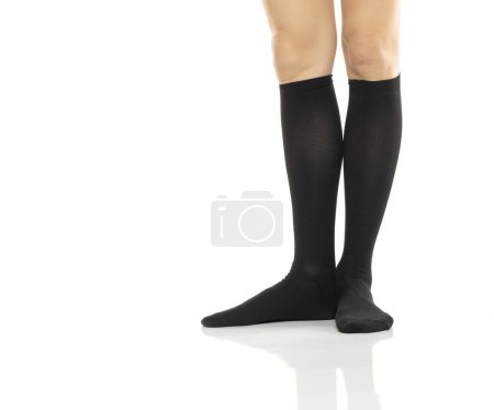 Photo for Female legs in compression Hosiery. Medical stockings, tights, socks, calves and sleeves for varicose veins and venouse therapy. Clinical knits. Sock for sports isolated on white studio background - Royalty Free Image