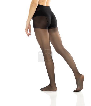 Foto de Mujer con hermosas piernas largas y medias negras, aislada sobre fondo blanco estudio. Trasera, vista trasera - Imagen libre de derechos