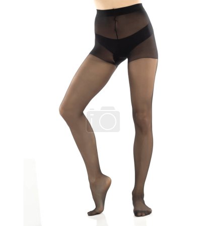 Foto de Mujer con hermosas piernas largas y medias negras, aislada sobre fondo blanco estudio. Vista frontal - Imagen libre de derechos