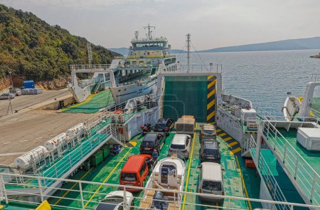 Photo for BRESTOVA, CROATIA - April 25 2020: Boarding the passenger and vehicle ferry that runs between Brestova and Porozina on Cres island. - Royalty Free Image
