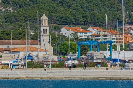 Photo for CRES, CROATIA - April 25 2020: Coastal view of the old town port with anchored small motorboats. - Royalty Free Image