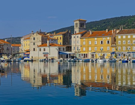 Photo for CRES, CROATIA - April 25 2020: Coastal view of the old town port with anchored small motorboats. - Royalty Free Image