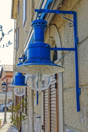 Photo for CRES, CROATIA - April 25 2020: Blue electric lamps in retro style at the old fisherman house in Cres town port. - Royalty Free Image