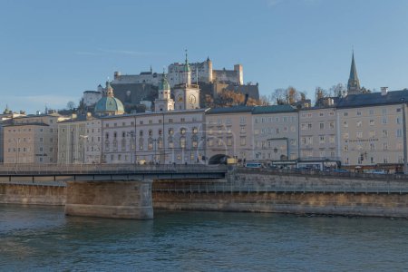 Photo for SALZBURG, AUSTRIA, FEBRUARY 22, 2020: Beautiful view of the city center with the main bridge Staatsbruke over the Salzach river and in the background Festung Hohensalzburg citadel. - Royalty Free Image