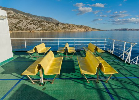 Photo for Benches on the ferry which crosses the Velebit Channel - Royalty Free Image