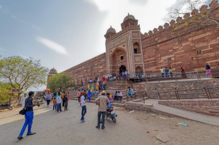 Photo for FATEHPUR SIKRI, INDIA - MARCH 4 2018: Visitors sightseeing Badshahi Darwaza of the old mosque, which was reserved for emperor to join the congregational prayer. - Royalty Free Image