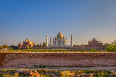 Photo for AGRA, INDIA - MARCH 4 2018: Tourists sighteseeing, exploring and admiring famous Taj Mahal view from across Yamuna river. - Royalty Free Image