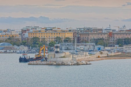 Photo for BARI, ITALY - September 26, 2019 Renovation of the coast by the green lighthouse in the city port. - Royalty Free Image